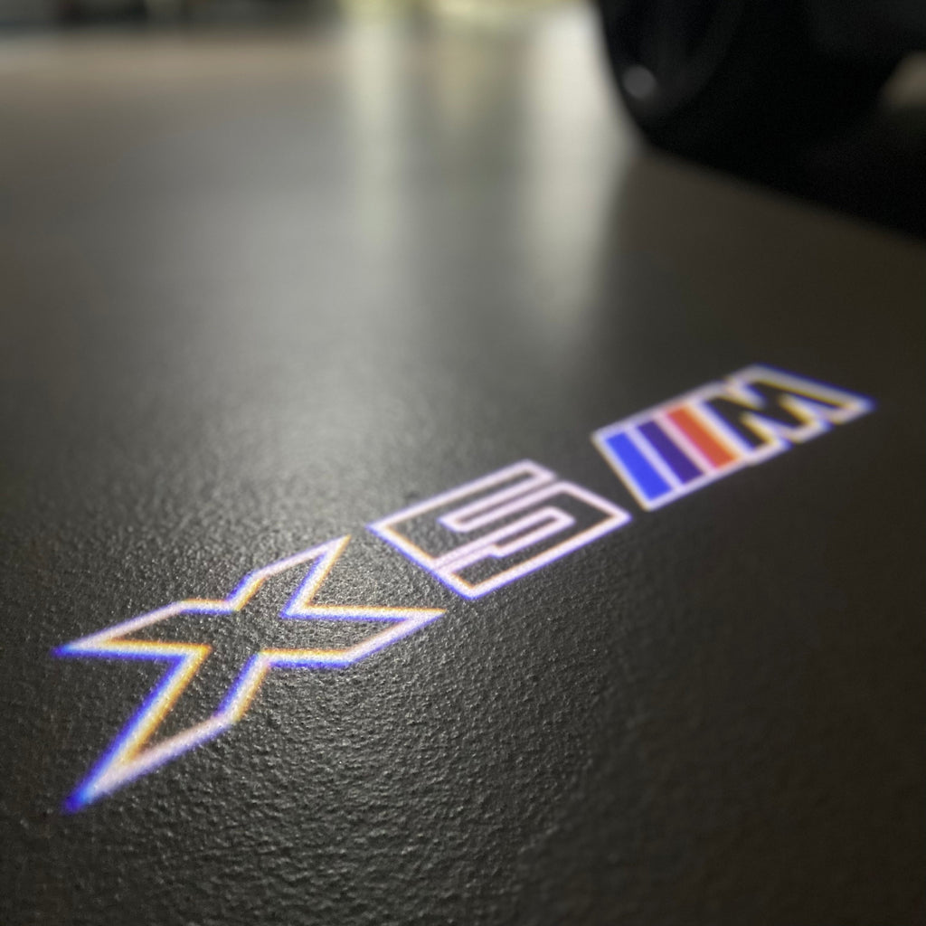 BMW X5M LOGO PROJECTOT LIGHTS (quantity 1 = 1 sets/2 door lights)Nr.bmw00108