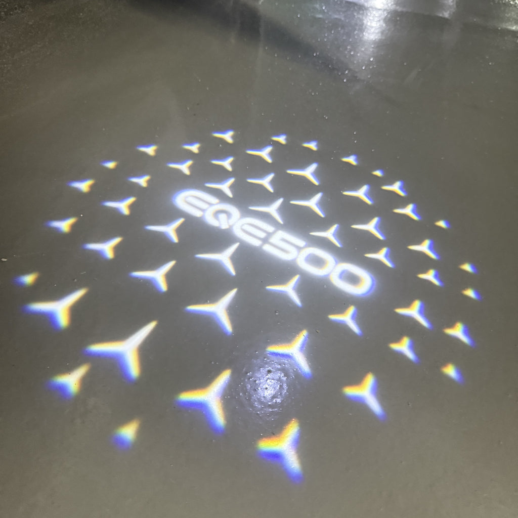 MERCEDES BENZ EQE 500 LOGO PROJECTOT LIGHTS  (quantity 1 = 1 set /2 door lights with 2 logo films)Nr.02M176