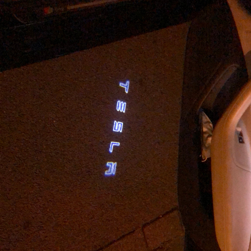 TESLA LOGO PROJECROTR LIGHTS Nr.1502 (quantità 1 = 2 pellicole logo / 2 luci per porta)