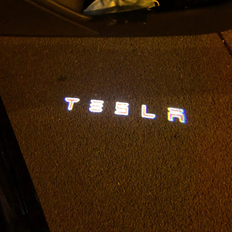 TESLA LOGO PROJECROTR LIGHTS Nr.1504 (quantità 1 = 2 pellicole logo / 2 luci per porta)