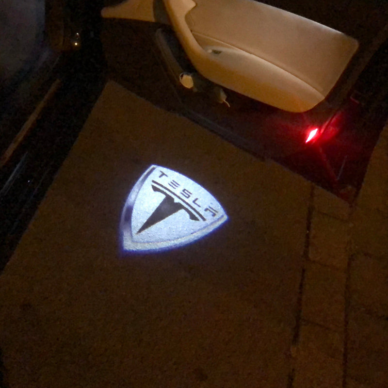 TESLA LOGO PROJECROTR LIGHTS Nr.1505 (quantità 1 = 2 pellicole logo / 2 luci per porta)