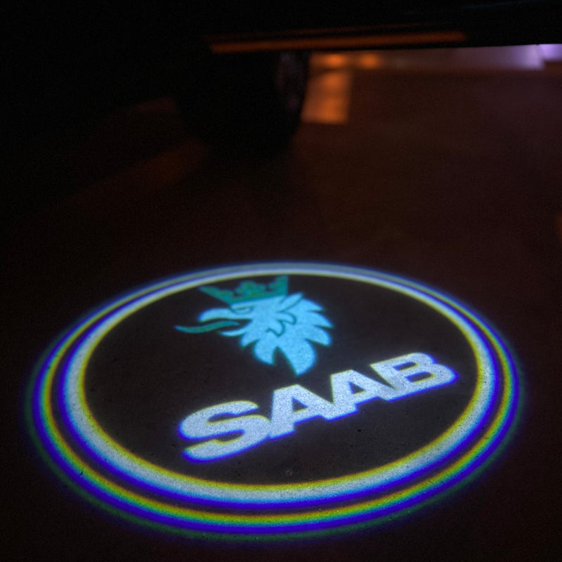 SAAB Original LOGO PROJECROTR LIGHTS Nr.25123 (quantità 1 = 1 set/2 luci porta)