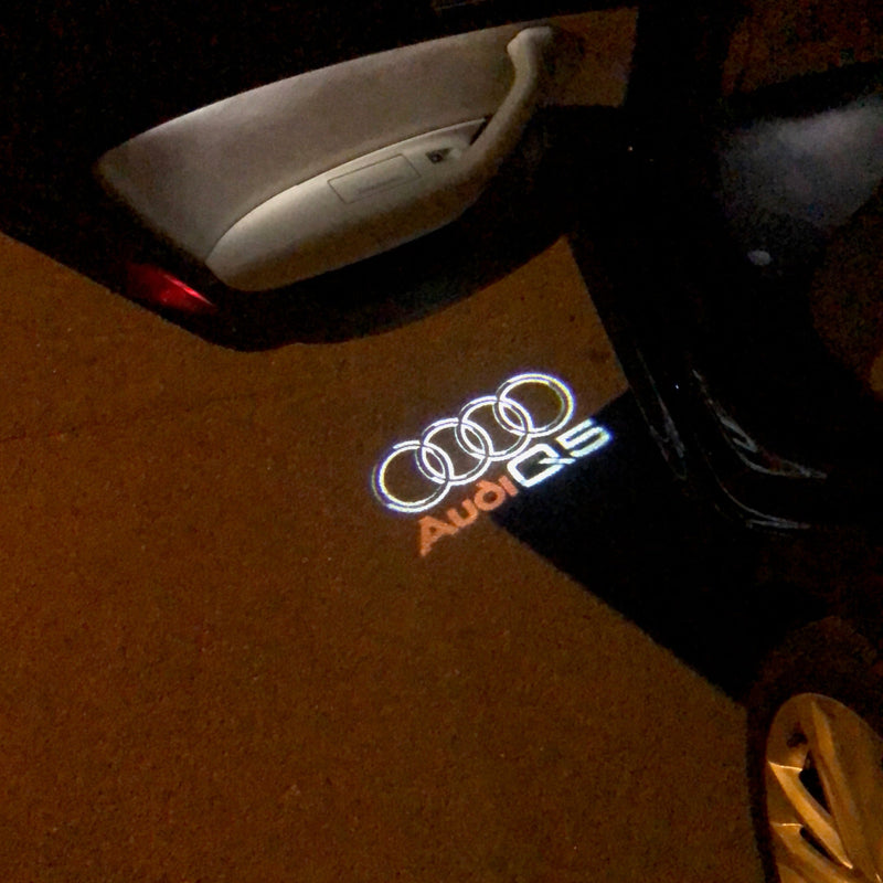 AUDI Q5 LOGO PROJECTOT LIGHTS Nr.48 (quantità 1 = 2 pellicole logo /2 luci porta） 